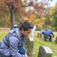 Volunteer cleaning a tombstone